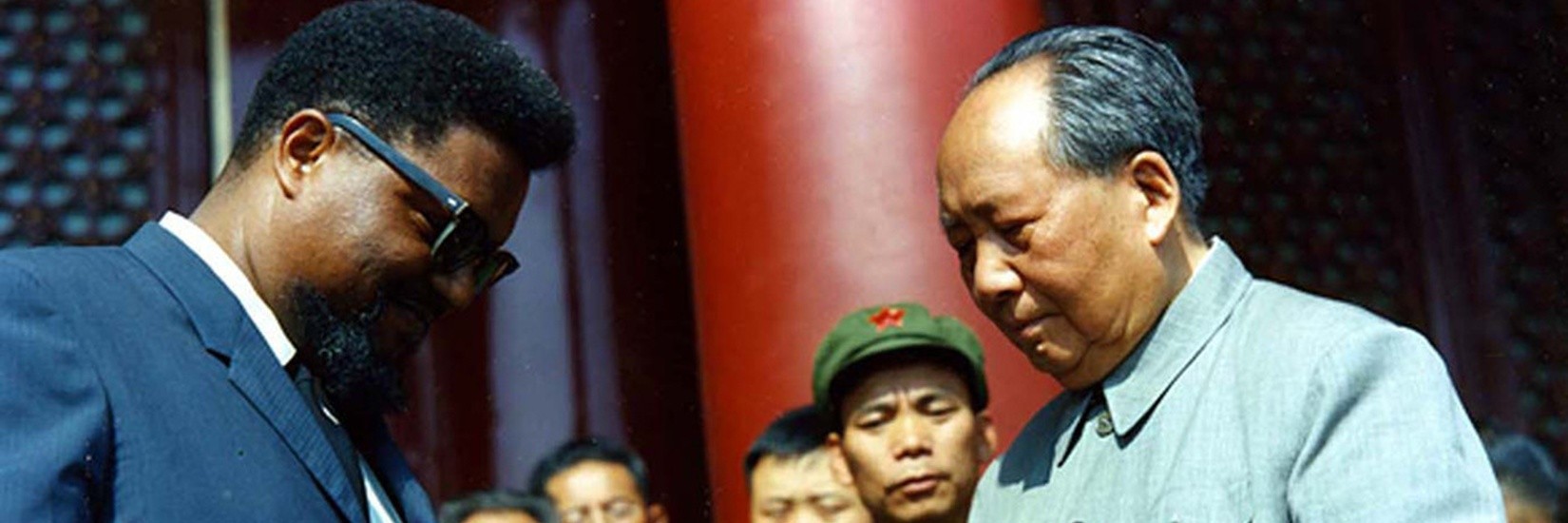 Chinese leader Mao Zedong signing a copy of his "Little Red Book" for American civil rights activist Robert F. Williams atop the Tiananmen Gate in Beijing on October 1, 1966.